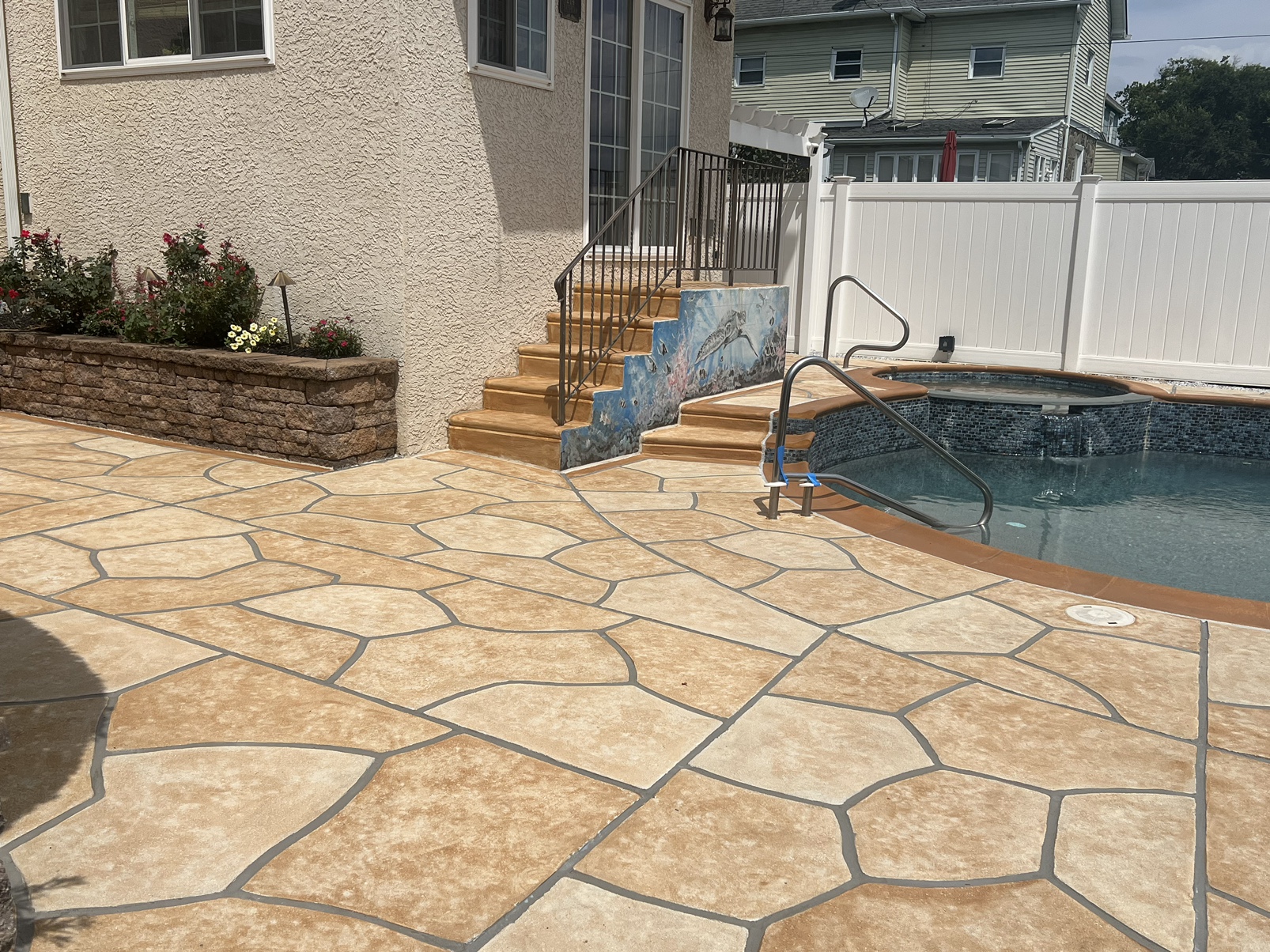 RenuKrete Tuscany-style resurfaced pool deck featuring warm earth tones in Marlton, NJ