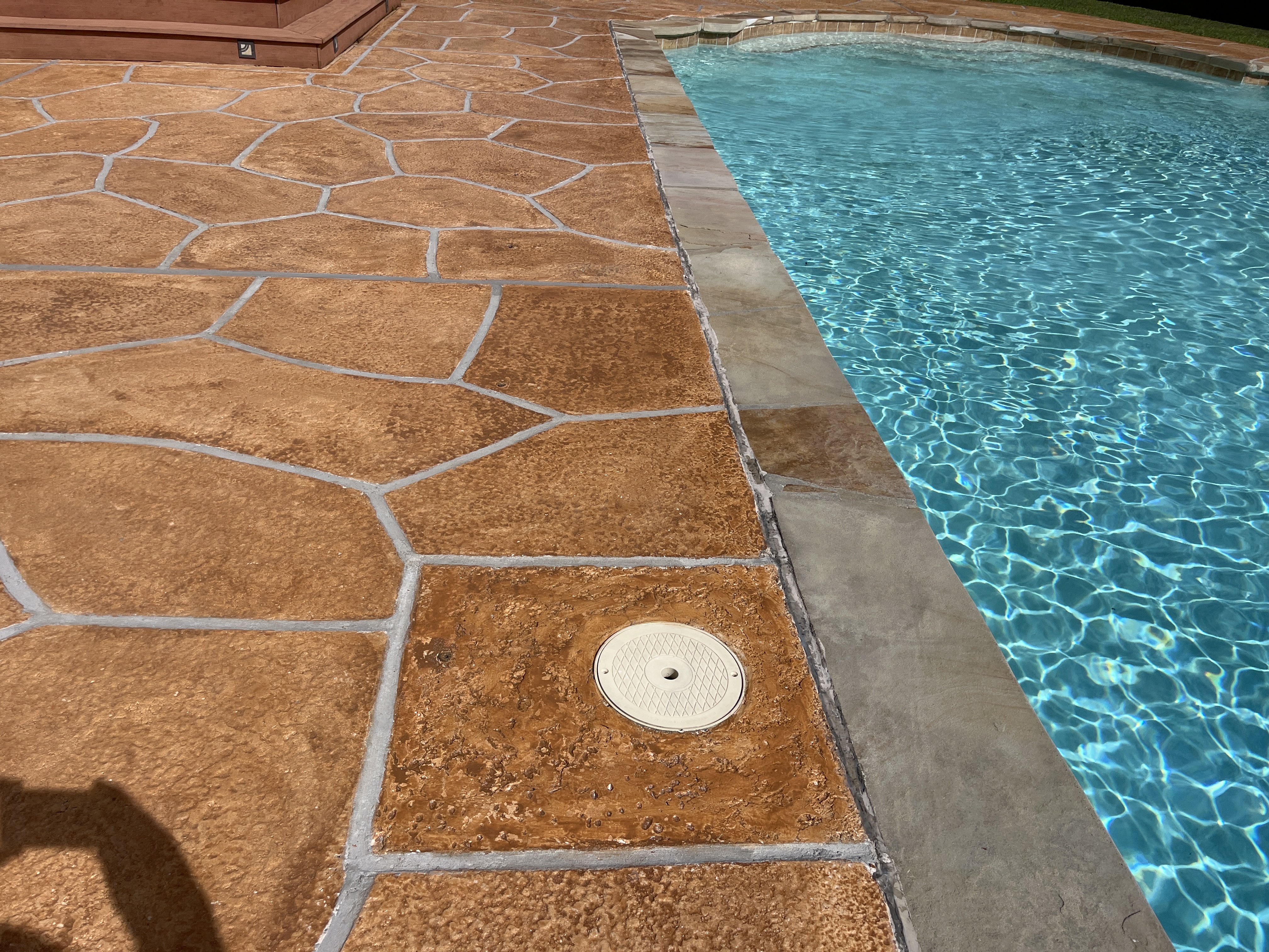 Pool deck resurfaced in Tuscany finish showing natural Mediterranean coloring