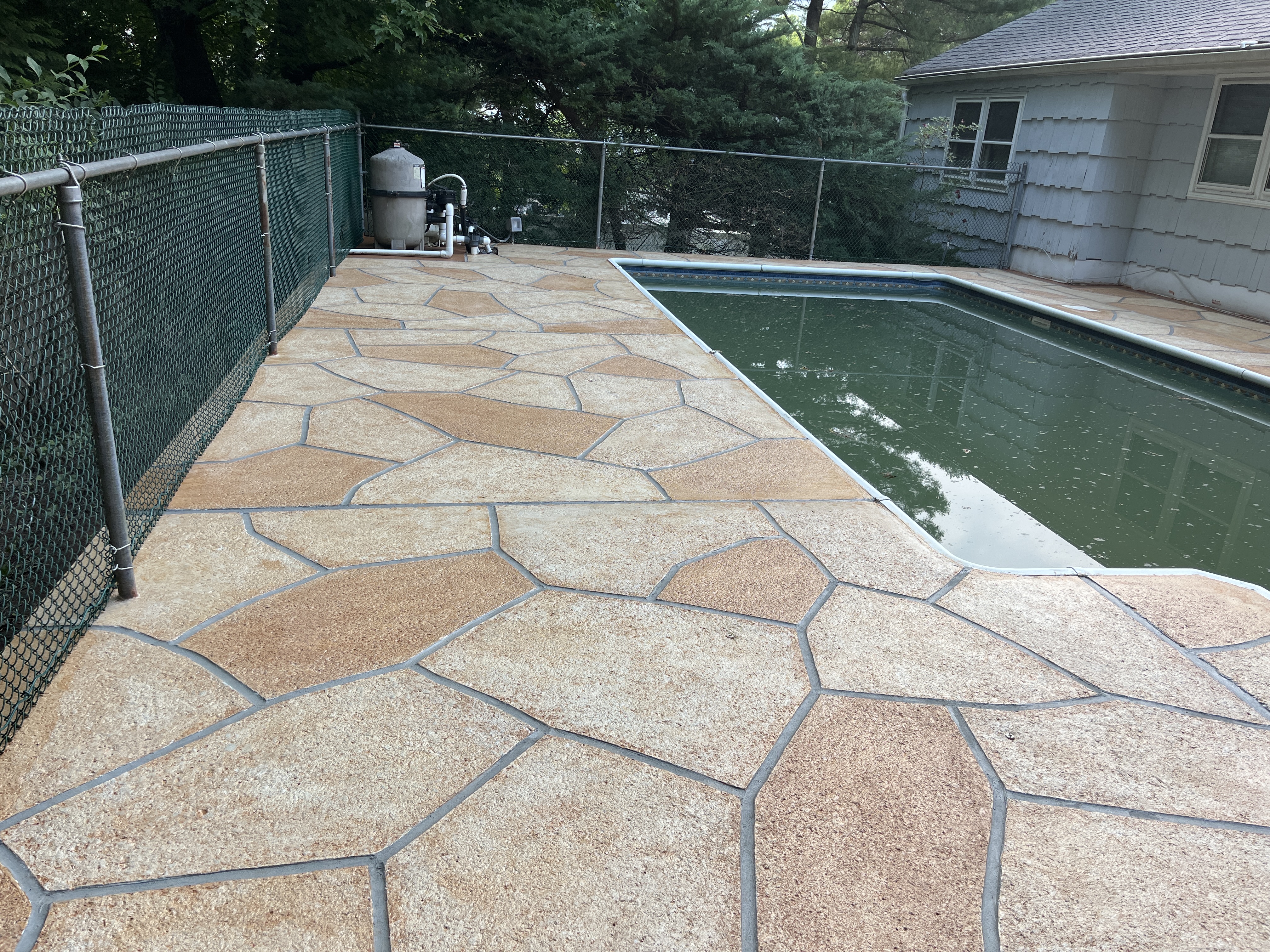Pool deck resurfaced in Tuscany finish showing natural Mediterranean coloring